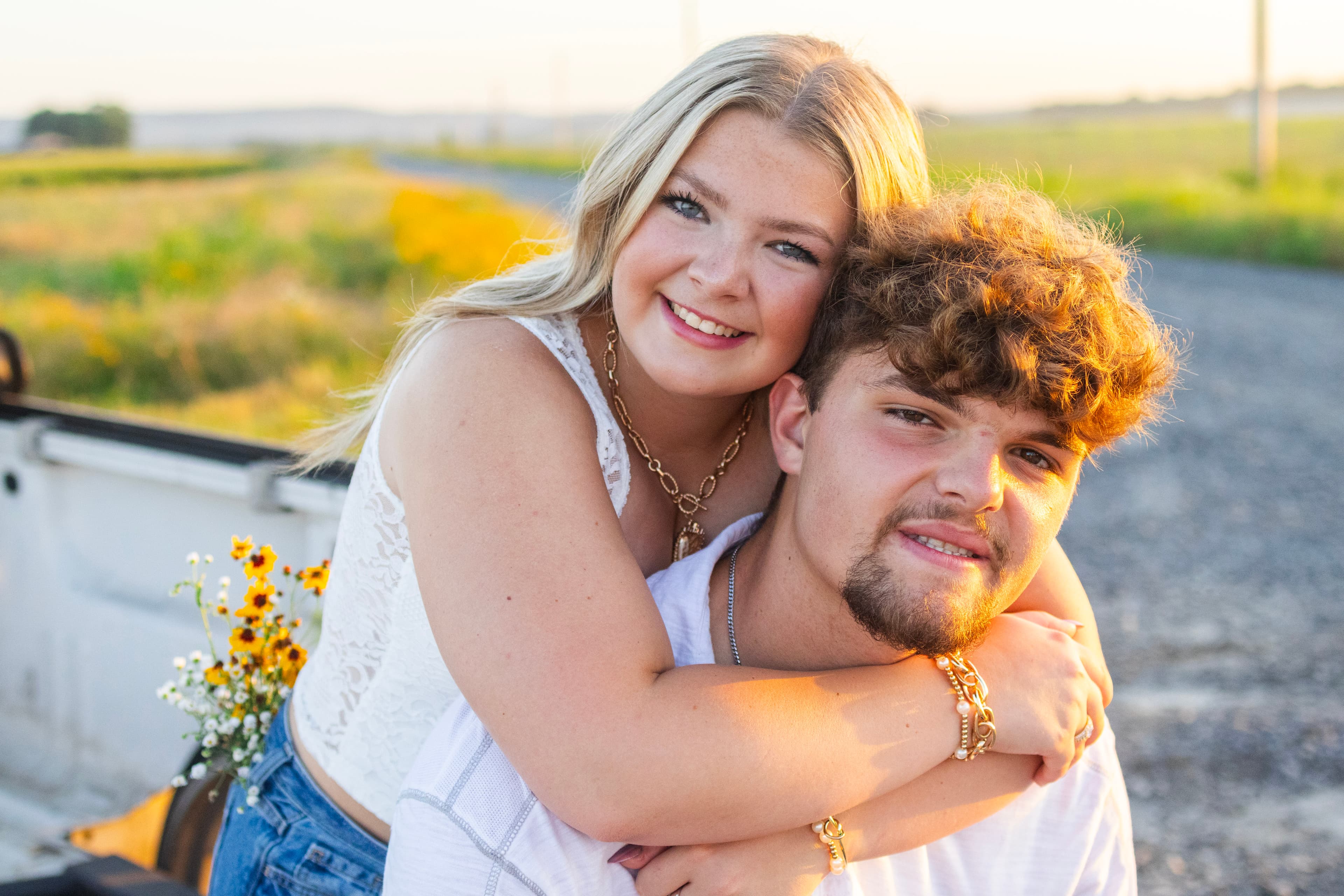 Couple embracing in warm light during an outdoor session near Lollie