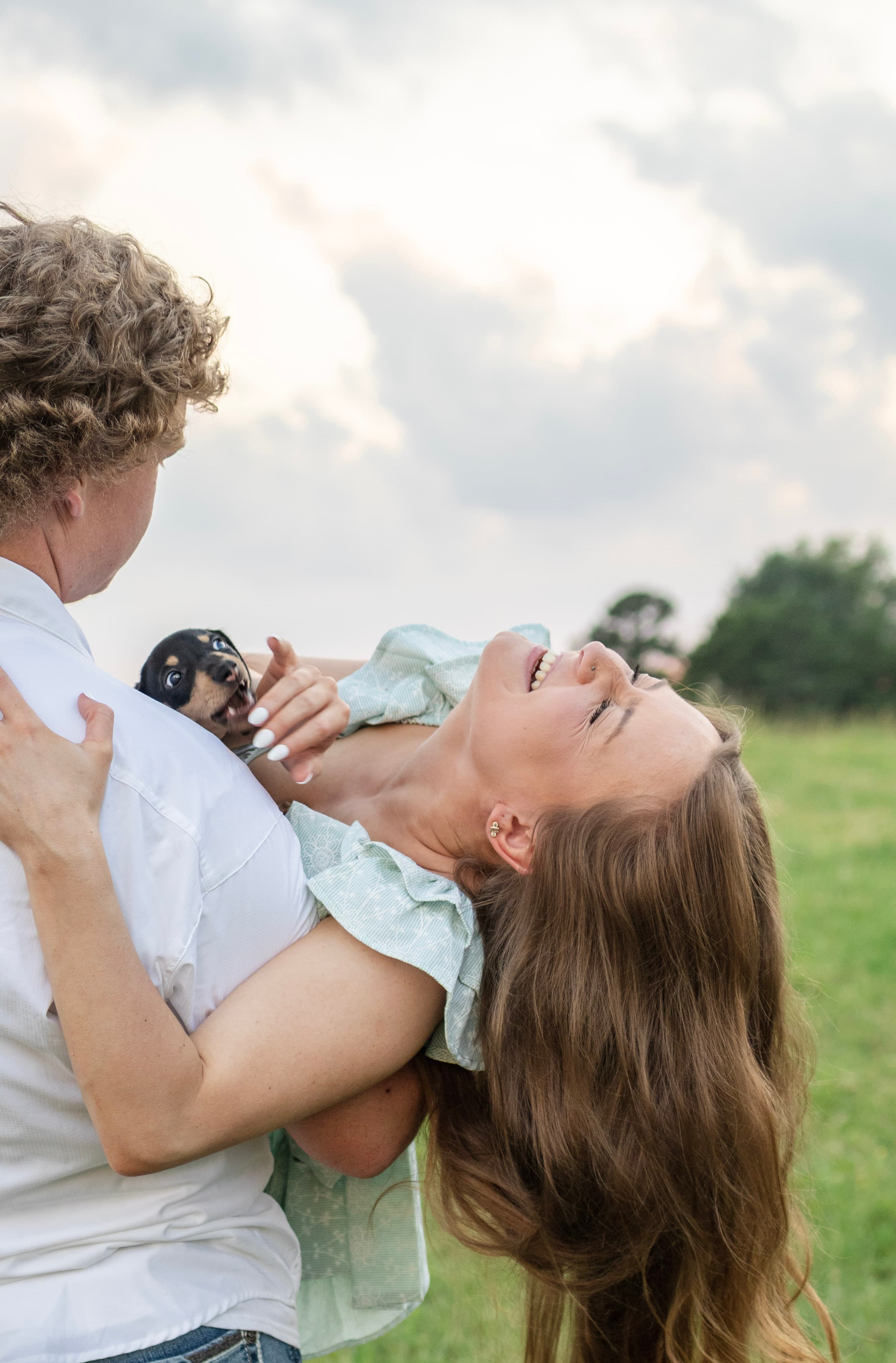 Couple laughing together in an outdoor field